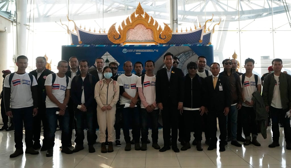 Thailand’s Foreign Minister Parnpree Bahiddha-Nukara, seventh from left, poses for photographers with Thai hostages who were freed from Hamas after they arrived in Thailand on Thursday. Photo: AP Thailand’s Foreign Minister Parnpree Bahiddha-Nukara, seventh from left, poses for photographers with Thai hostages who were freed from Hamas after they arrived in Thailand on Thursday. Photo: AP