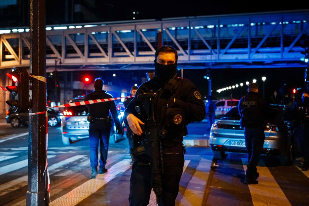 A police officer stands guard at the scene of a stabbing near the Eiffel Tower in Paris on Saturday night. Photo: AFP A police officer stands guard at the scene of a stabbing near the Eiffel Tower in Paris on Saturday night. Photo: AFP