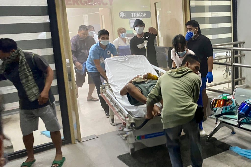 Patients at Manuel J. Santos Hospital in Butuan City, southern Philippines, are evacuated after a powerful earthquake struck early Sunday, prompting many villagers to flee their homes in panic. Photo: AP Patients at Manuel J. Santos Hospital in Butuan City, southern Philippines, are evacuated after a powerful earthquake struck early Sunday, prompting many villagers to flee their homes in panic. Photo: AP