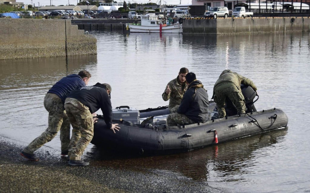 US military personnel leave a port on the island of Yakushima on December 4 to search for crew and wreckage of the CV-22 Osprey aircraft. Photo: Kyodo