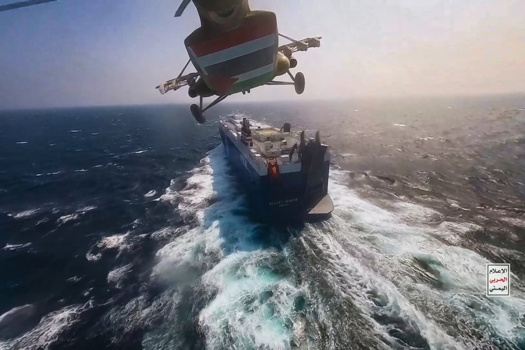 A Houthi helicopter flying over the cargo ship Galaxy Leader as Houthis seize it in the Red Sea. Photo: dpa