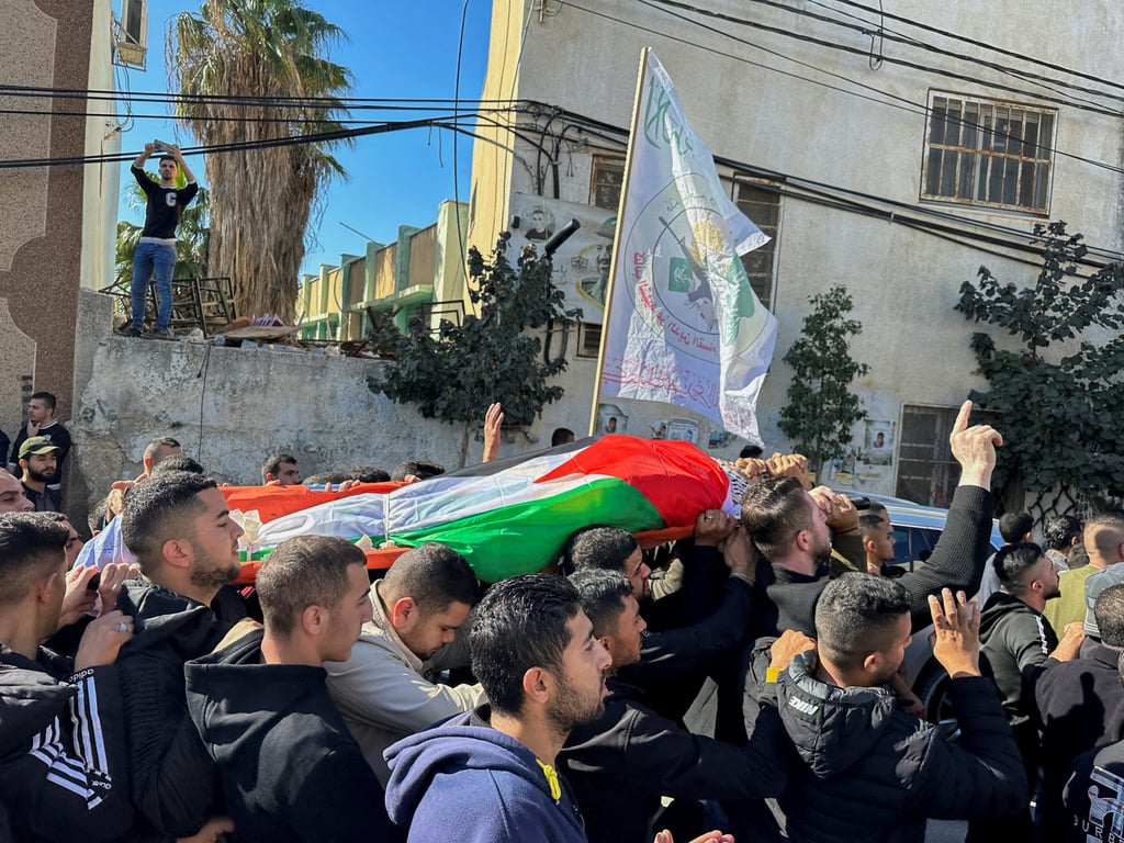 Mourners carry the body of Ahmad Assi, who was killed in an Israeli settler raid, during his funeral near Salfit in the Israeli-occupied West Bank on Sunday. Photo: Reuters