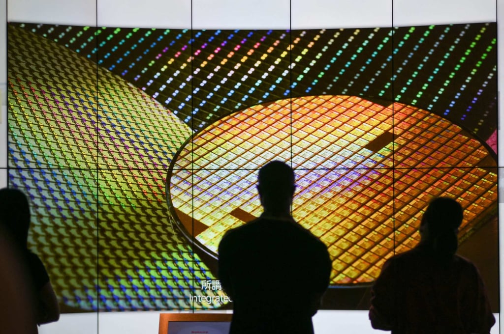 Visitors watch a wafer shown on screens at the Taiwan Semiconductor Manufacturing Company (TSMC) Renovation Museum at the Hsinchu Science Park in Hsinchu on July 5, 2023. Taiwanese chip giant TSMC said on August 8, 2023 that its board had approved a USD 3.8 billion investment in a factory in Germany, as well as a capital injection of USD 4.5 billion to its Arizona plant. Photo: AFP