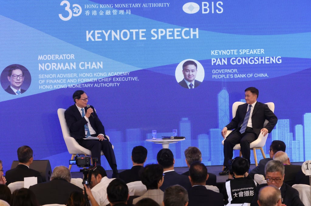 Norman Chan Tak-lam, a senior adviser with Hong Kong Academy of Finance and the former chief executive of the Hong Kong Monetary Authority (left), in conversation with People’s Bank of China Governor Pan Gongsheng at the HKMA-BIS High-Level Conference in Admiralty. Photo: Dickson Lee