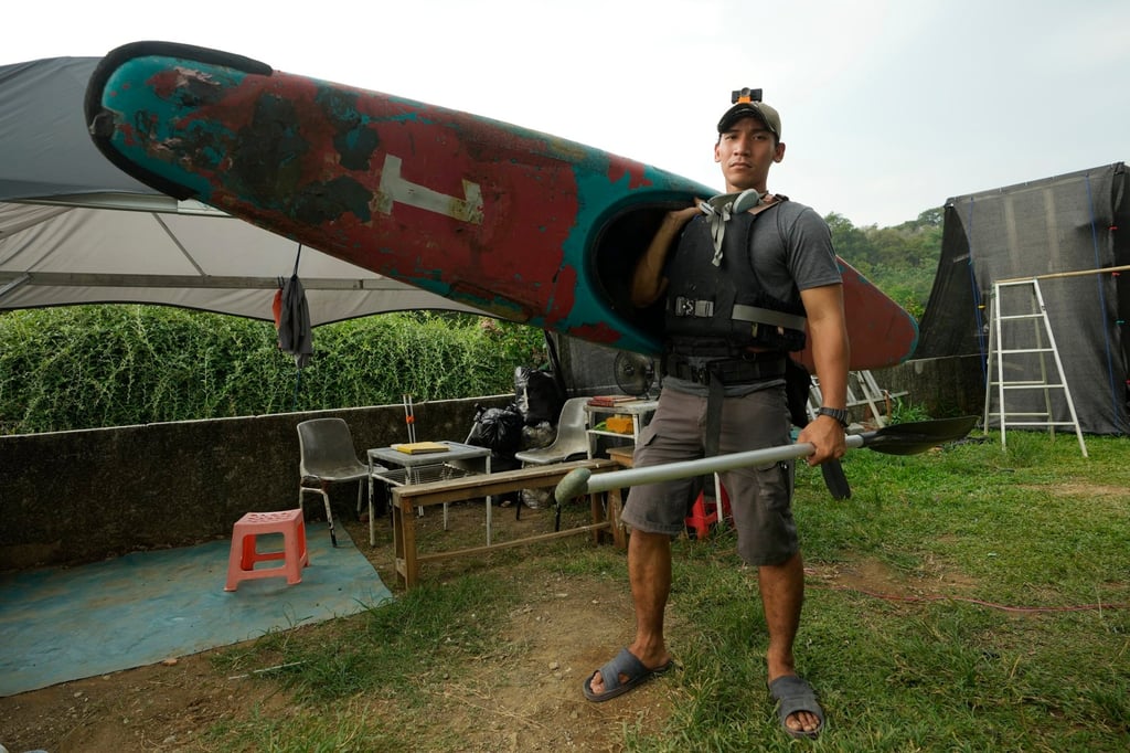 Environmental activist Giri Marhara prepares to pick up trash at Situ Gede lake in Bogor, West Java, Indonesia in October. Photo: AP Environmental activist Giri Marhara prepares to pick up trash at Situ Gede lake in Bogor, West Java, Indonesia in October. Photo: AP