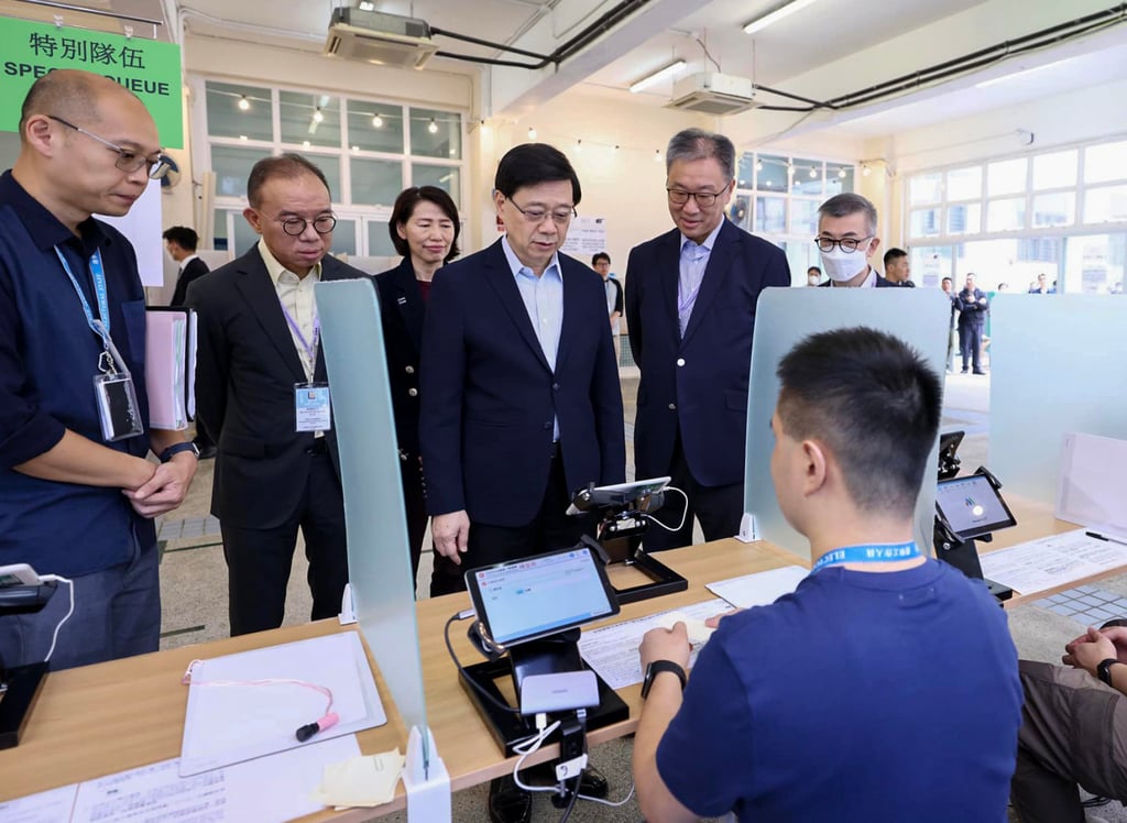 Chief Executive John Lee (centre) visits a polling station in Heng Fa Chuen on Saturday morning. “I have full confidence in Sunday’s election,” he said. Photo: Facebook/@John KC Lee