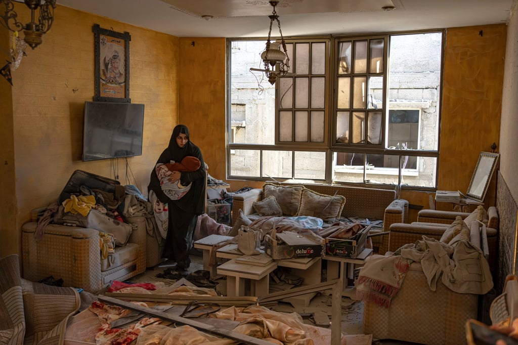 A Palestinian woman holds her child after an Israeli strike on her neighbourhood in Rafah, Gaza Strip, on Saturday. Photo: AP A Palestinian woman holds her child after an Israeli strike on her neighbourhood in Rafah, Gaza Strip, on Saturday. Photo: AP