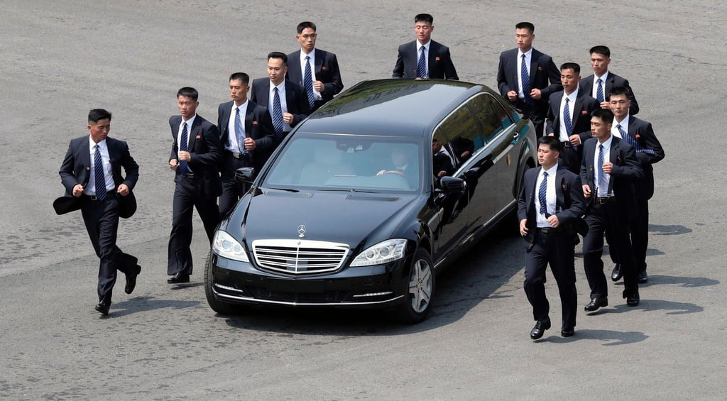 North Korean security personnel run by a car carrying leader Kim Jong-un at the border village of Panmunjom in April 2018. Photo: Korea Summit Press Pool via AP