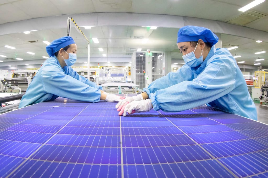 Employees work on solar photovoltaic modules at a factory in Haian in China’s eastern Jiangsu province on November 21, 2023. Photo: AFP