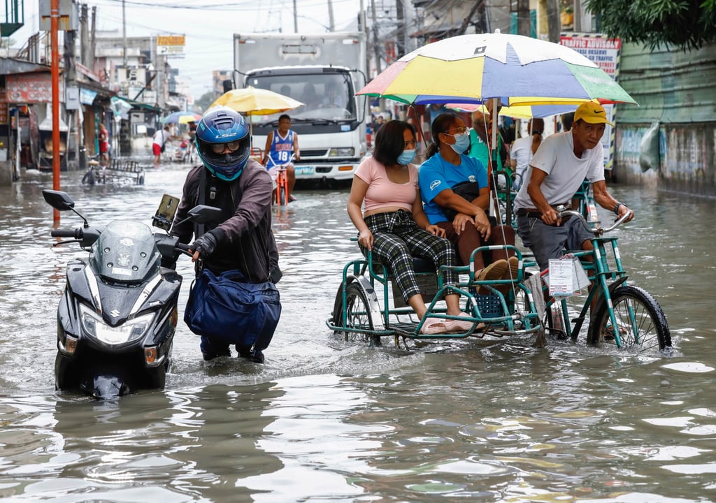 People make their way through a flood in Valenzuela City, Metro Manila, in July as a result of Typhoon Doksuri. The Philippines has been affected by far fewer major storms this year than is typical. Photo: EPA-EFE