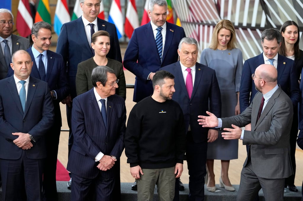 European Council President Charles Michel (front right) speaks with Ukraine’s President Volodymyr Zelensky (front, second from right), and Hungary’s Prime Minister Viktor Orban (pink tie), as they pose with other EU leaders for a group photo at an EU summit in Brussels. Photo: AP