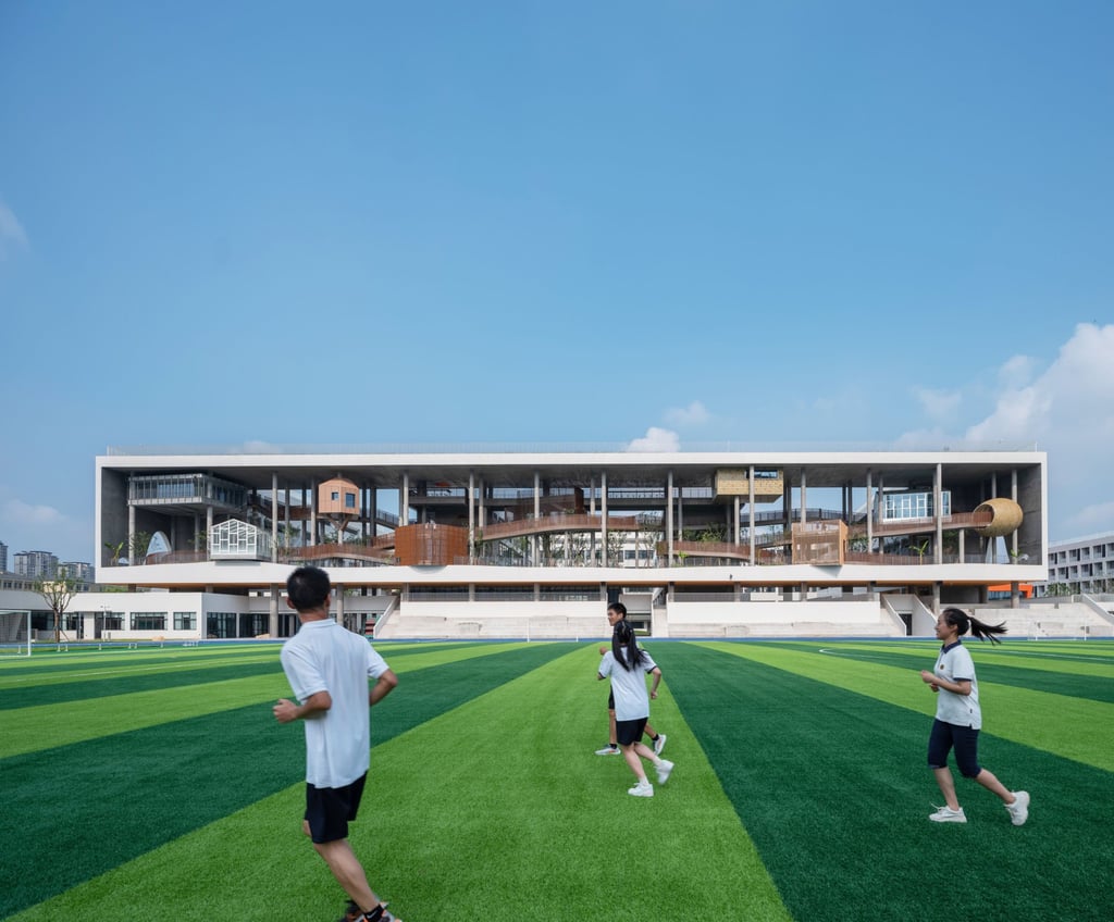 Students jog on a playing field at Huizhen High School. Photo: Courtesy of Approach Design Studio