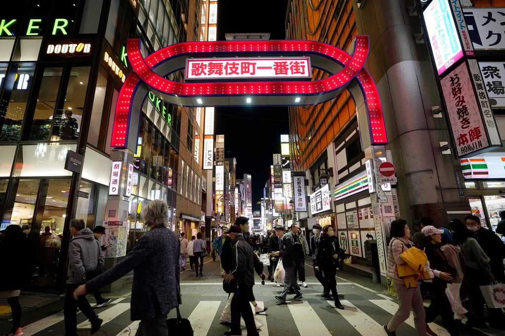 Pedestrians walk past an entrance at Kabukicho in Tokyo’s Shinjuku district. Photo: EPA-EFE