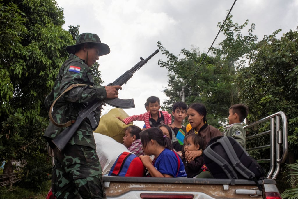 A member of the insurgent Karenni Nationalities Defence Force rescues civilians trapped amid air strikes, during a battle to take over Loikaw in Kayah State. Photo: Reuters