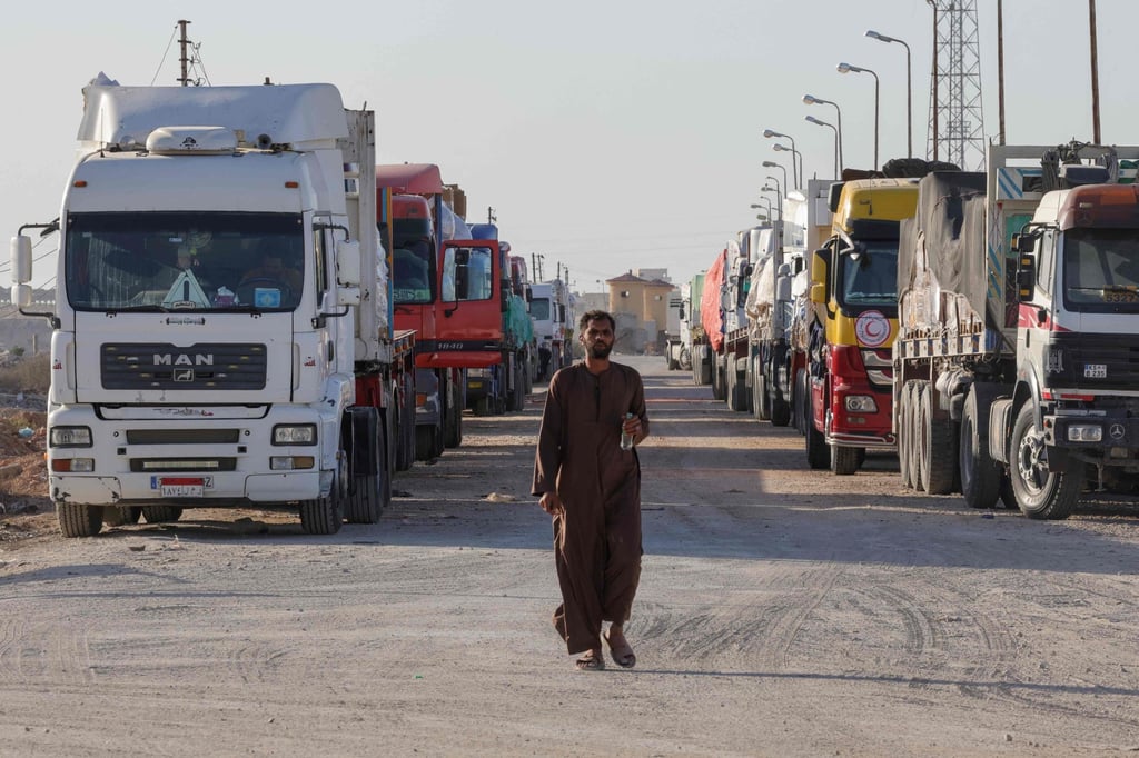 Trucks with humanitarian aid wait to enter the Palestinian side of Rafah on the Egyptian border on Monday. Photo: AFP