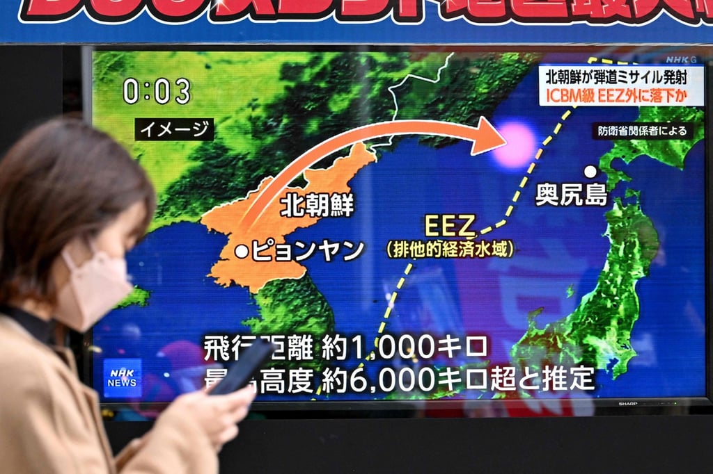 A woman walks past a television screen in Tokyo on Monday broadcasting a news report on the North Korean missile launch. Photo: AFP A woman walks past a television screen in Tokyo on Monday broadcasting a news report on the North Korean missile launch. Photo: AFP