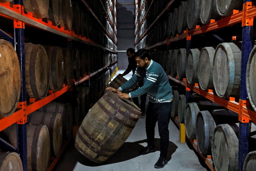 Workers move whisky barrels at Piccadily Distilleries. Photo: Reuters Workers move whisky barrels at Piccadily Distilleries. Photo: Reuters