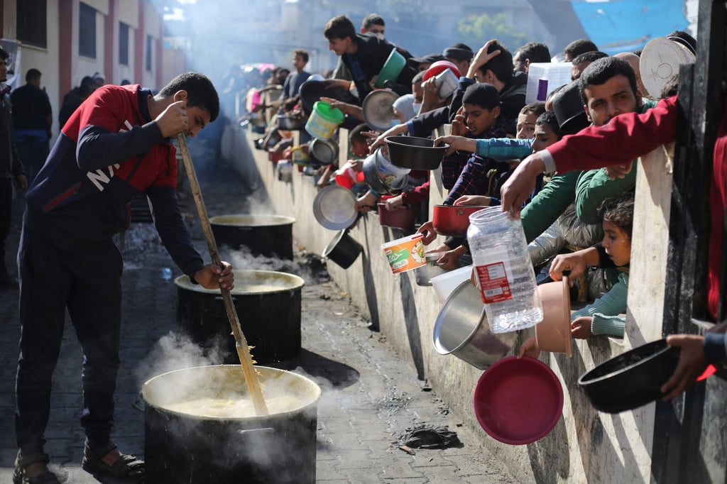 Palestinians line up for a meal in Rafah in the Gaza Strip on Wednesday. Photo: AP