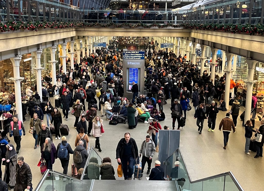 Passengers wait at the Eurostar entrance in St Pancras station in London on Thursday. Photo: PA via AP