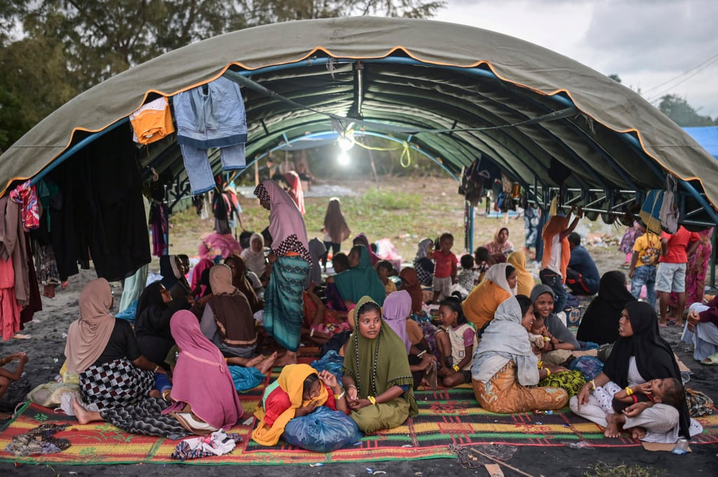 Ethnic Rohingya women sit under a tent at their camp near a beach in Pidie, Aceh province, Indonesia, on December 15. Photo: AP