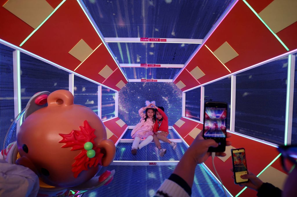 Children pose at an installation in Harbour City. The shopping centre expects 280,000 visitors will enjoy the festivities on Christmas Eve. Photo: Jonathan Wong Children pose at an installation in Harbour City. The shopping centre expects 280,000 visitors will enjoy the festivities on Christmas Eve. Photo: Jonathan Wong