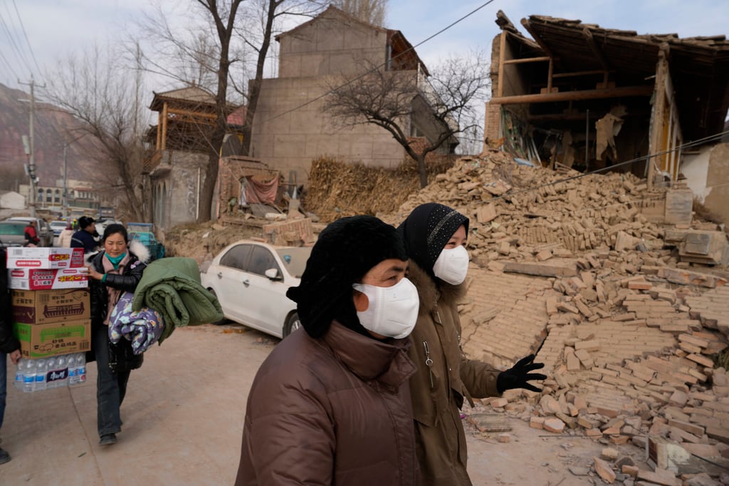 Residents near a house that crumbled after an earthquake in Dahejia town in northwestern China’s Gansu province that caused over 100 fatalities and left hundreds injured. Photo: AP/Ng Han Guan Residents near a house that crumbled after an earthquake in Dahejia town in northwestern China’s Gansu province that caused over 100 fatalities and left hundreds injured. Photo: AP/Ng Han Guan