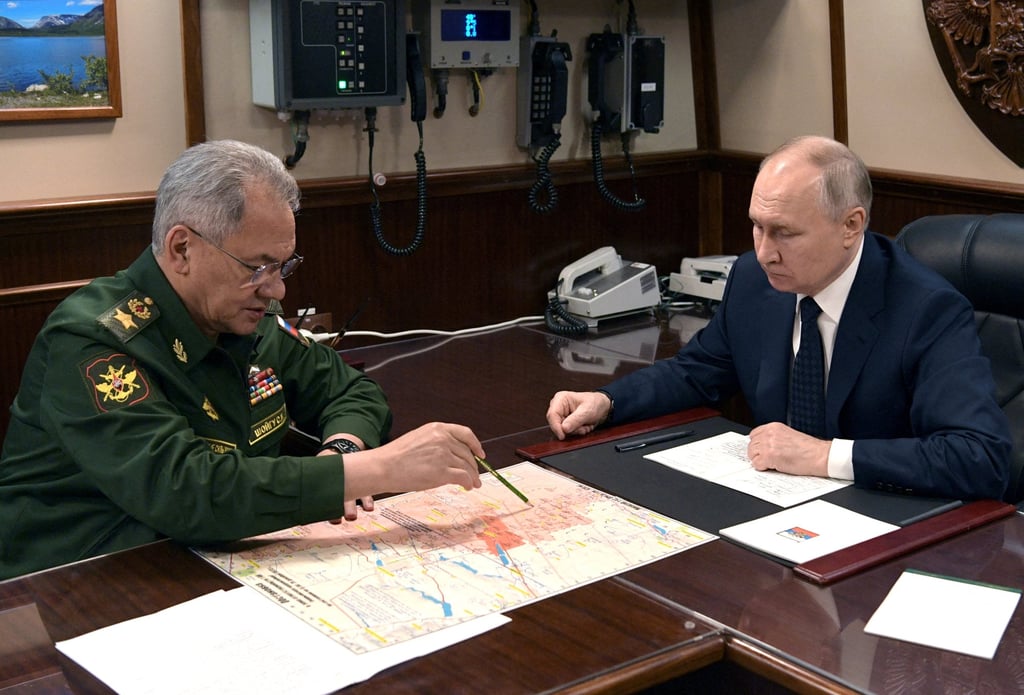 Russia’s President Vladimir Putin (right) listens to Defence Minister Sergei Shoigu during a meeting in St Petersburg on Monday. Photo: Sputnik via Reuters