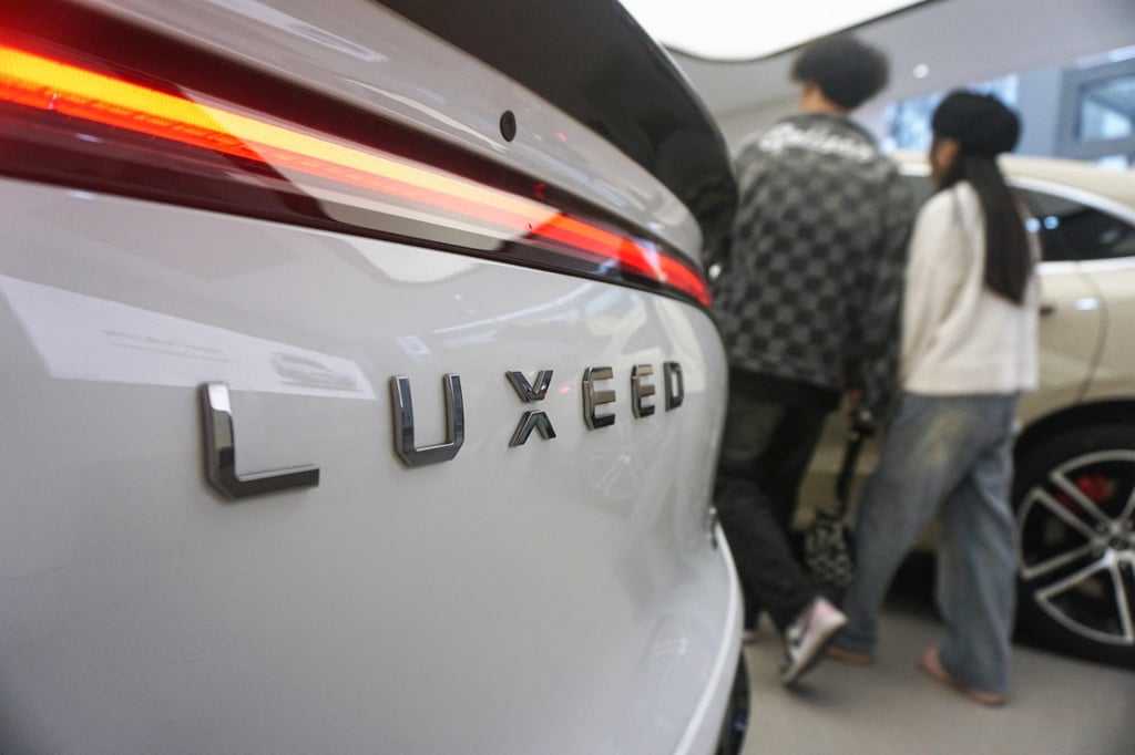 Visitors look at the Luxeed S7, the first sedan produced by Chinese tech giant Huawei, at a Huawei showroom in Hangzhou, in Chinas eastern Zhejiang province on December 12, 2023. Photo: AFP