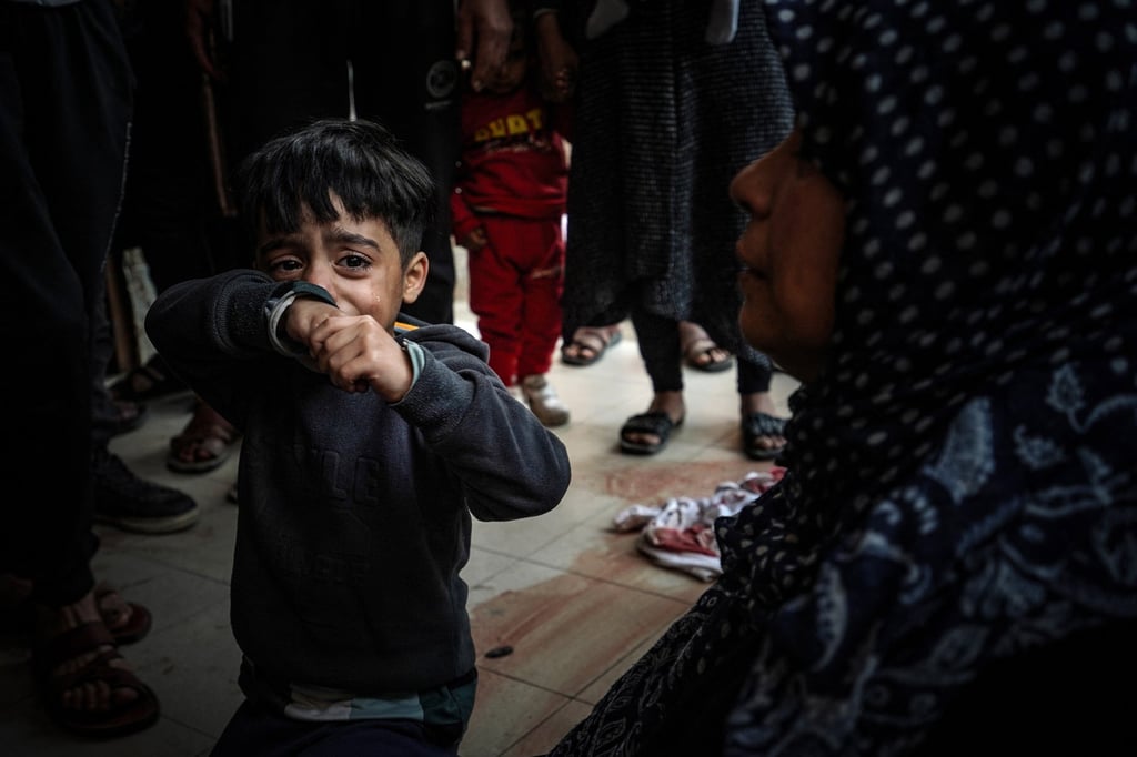 A child cries as people mourn loved ones killed during Israeli bombardments in southern Gaza on Wednesday. Photo: AFP