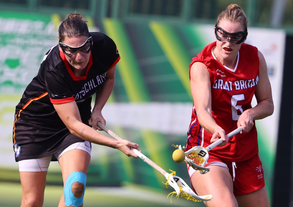 Great Britain’s Emma Oakley (right) and Germany’s Clara Kiekbusch battle for possession during their World Lacrosse Super Sixes final at Wong Chuk Hang Recreation Ground. Photo: Dickson Lee