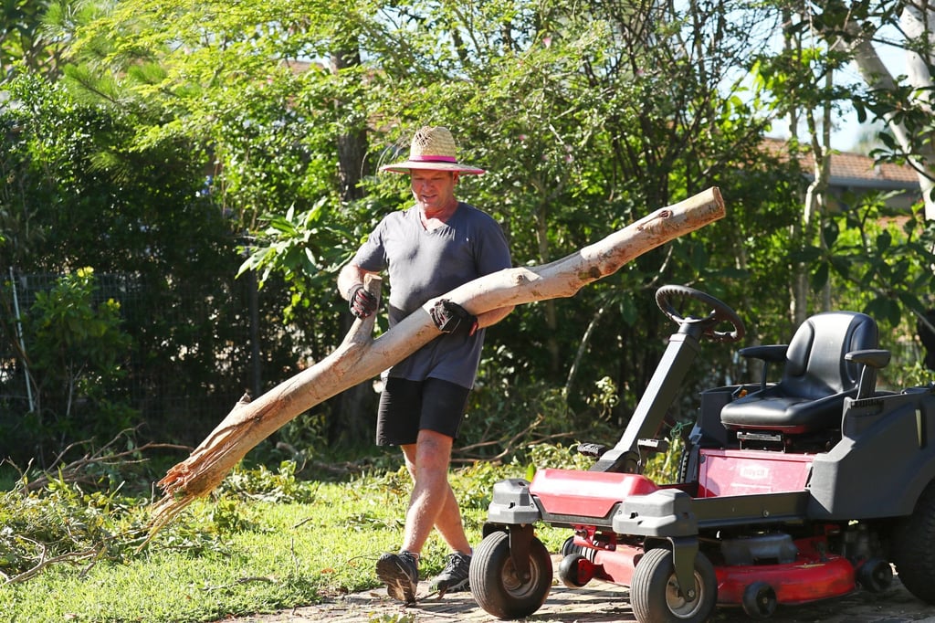 A local resident cleans up after storm damage in Oxenford on the Gold Coast, Queensland, Australia, on December 28, 2023. Photo: EPA-EFE