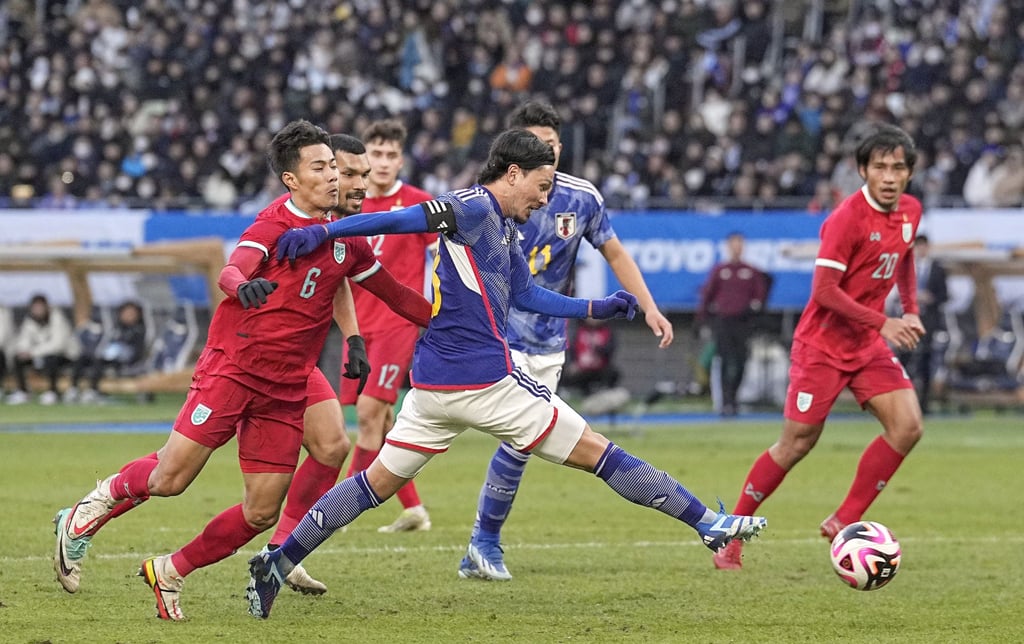 Japan’s Takumi Minamino scores his side’s fourth goal against Thailand at the National Stadium in Tokyo. Photo: Kyodo