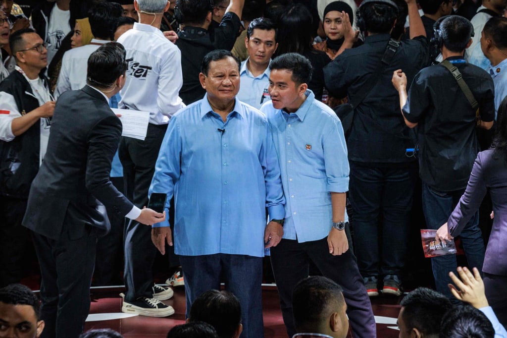 Gibran (centre, right) talks to running mate Prabowo Subianto (centre, left) after the first presidential election debate in Jakarta last month. Indonesia’s general elections are set to be held in February. Photo: AFP Gibran (centre, right) talks to running mate Prabowo Subianto (centre, left) after the first presidential election debate in Jakarta last month. Indonesia’s general elections are set to be held in February. Photo: AFP