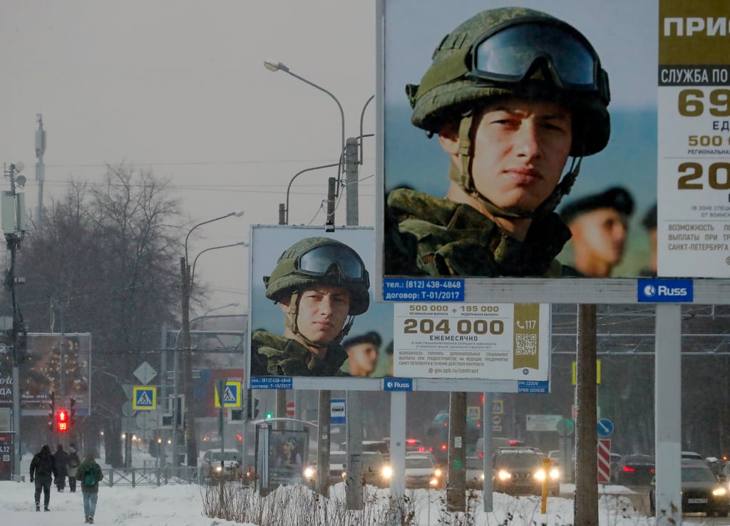 People walk past billboards encouraging people to enlist in the military. On Thursday, Moscow offered citizenship to foreigners who fight for Russia. Photo: EPA-EFE People walk past billboards encouraging people to enlist in the military. On Thursday, Moscow offered citizenship to foreigners who fight for Russia. Photo: EPA-EFE