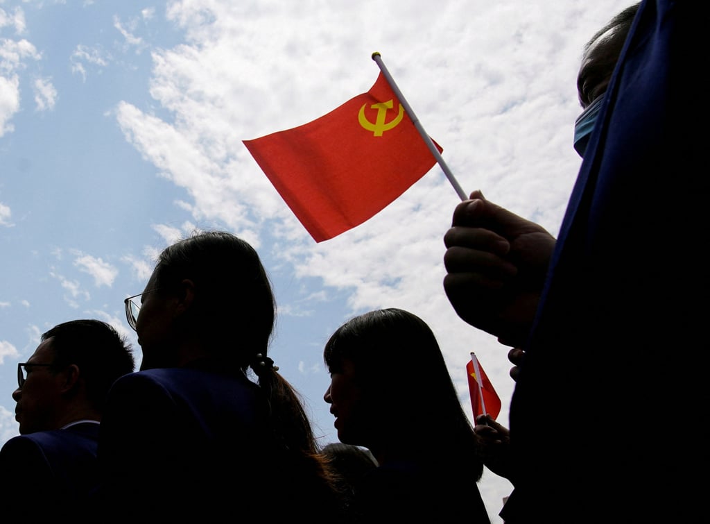 Visitors hold flags of the Communist Party of China at a 2021 exhibition in Shanghai celebrating the party’s 100th founding anniversary. Photo: Reuters Visitors hold flags of the Communist Party of China at a 2021 exhibition in Shanghai celebrating the party’s 100th founding anniversary. Photo: Reuters