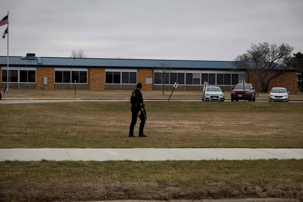 An armed police officer at the school. Photo: AFP