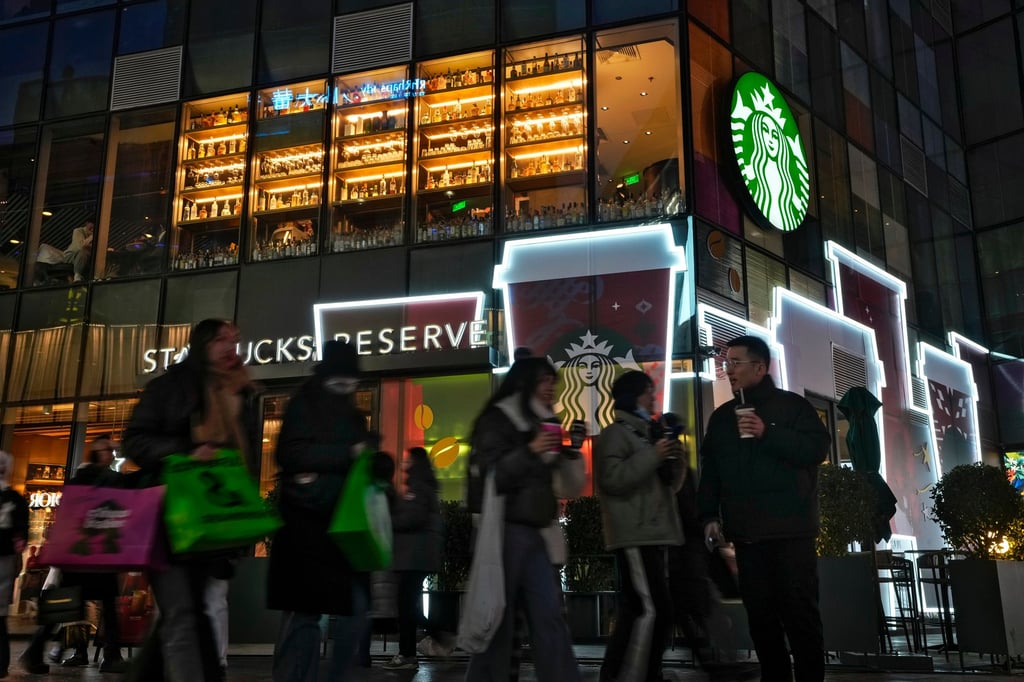 Shoppers walk by a Starbucks cafe at an outdoor shopping centre in Beijing on Saturday, Dec. 23, 2023. Photo: AP