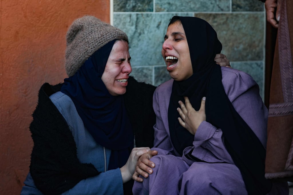 A woman (right) mourns her husband who was killed when the tent where they were sheltering was hit by Israeli bombardment, at the morgue of the Nasser medical centre in Khan Yunis in the southern Gaza Strip, on Thursday. Photo: AFP