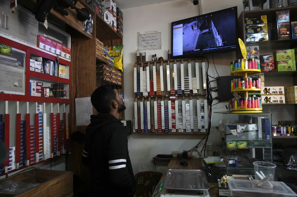 A man watches a replay of security camera footage in a smoke shop in the occupied West Bank village of Beit Rima. Photo: AP A man watches a replay of security camera footage in a smoke shop in the occupied West Bank village of Beit Rima. Photo: AP