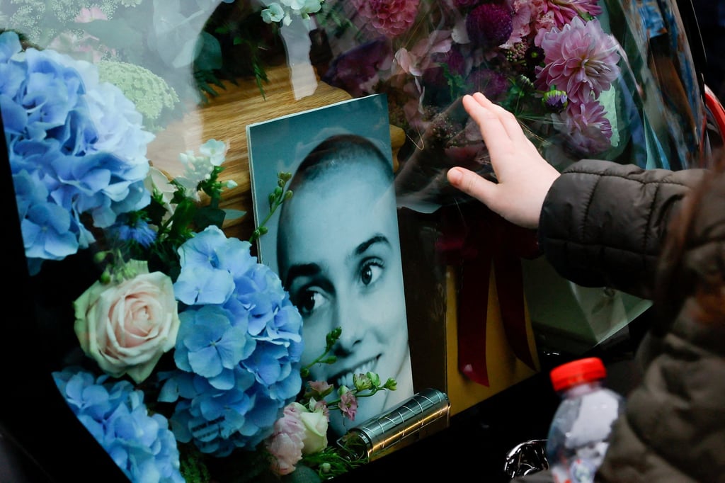 A person gestures behind a hearse carrying the coffin of late Irish singer Sinead O’Connor during her funeral procession in Bray, Ireland in August. Photo: Reuters A person gestures behind a hearse carrying the coffin of late Irish singer Sinead O’Connor during her funeral procession in Bray, Ireland in August. Photo: Reuters