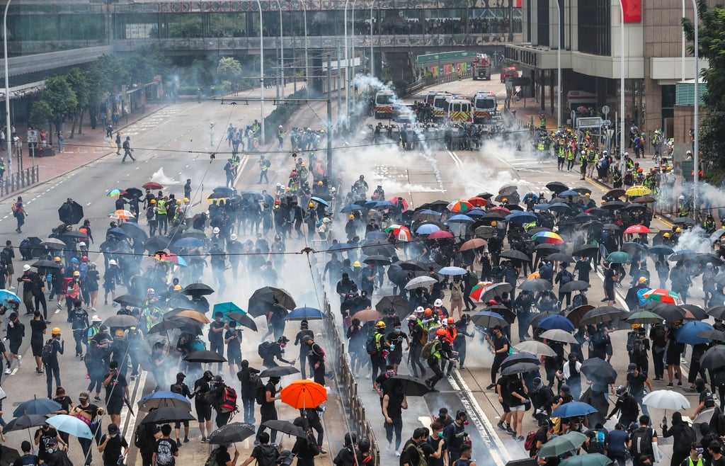 Protesters in Hong Kong react to tear gas following scuffles with police in 2019. Photo: Sam Tsang Protesters in Hong Kong react to tear gas following scuffles with police in 2019. Photo: Sam Tsang
