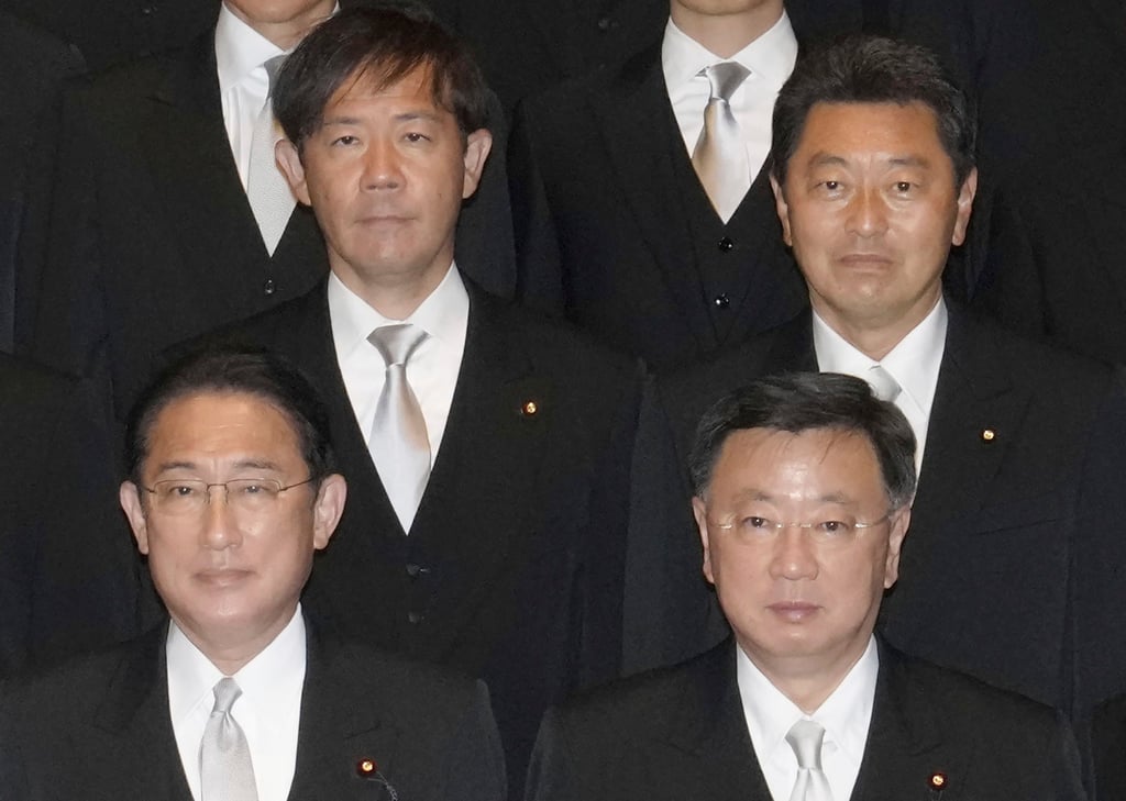 Yoshitaka Ikeda (behind right) poses with Prime Minister Fumio Kishida (front left) in Tokyo in November 2021. Ikeda was arrested on suspicion that he took funds from 2017 to 2022 and failed to report them. Photo: AP Yoshitaka Ikeda (behind right) poses with Prime Minister Fumio Kishida (front left) in Tokyo in November 2021. Ikeda was arrested on suspicion that he took funds from 2017 to 2022 and failed to report them. Photo: AP
