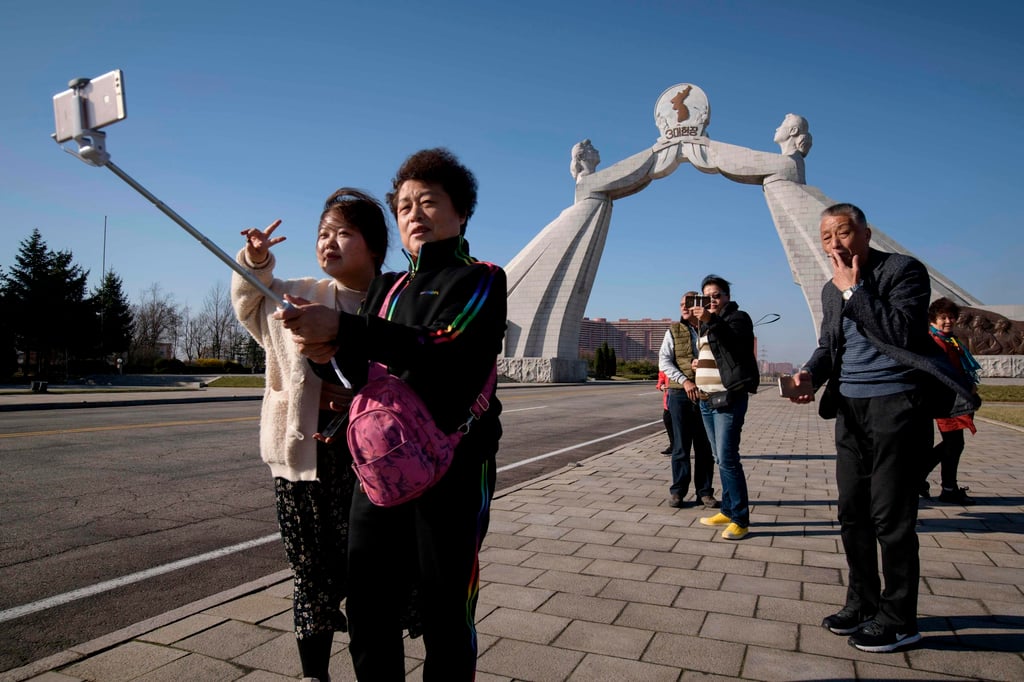Tourists from China pose for photos before the Three Charters monument in Pyongyang in February 2019. Tourists from China and Russia have previously been an important source of foreign currency for the cash-strapped nation. Photo: AFP Tourists from China pose for photos before the Three Charters monument in Pyongyang in February 2019. Tourists from China and Russia have previously been an important source of foreign currency for the cash-strapped nation. Photo: AFP