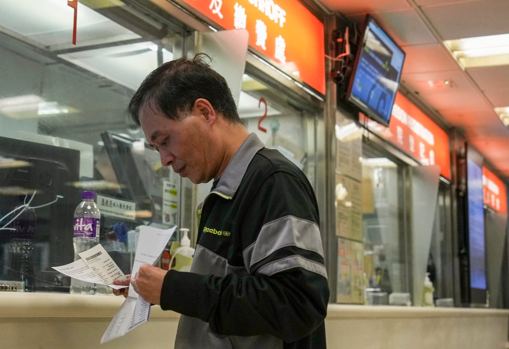 A man checks his bill at the A&E department of Queen Elizabeth Hospital in Jordan, Hong Kong, on January 9. Photo: Eugene Lee A man checks his bill at the A&E department of Queen Elizabeth Hospital in Jordan, Hong Kong, on January 9. Photo: Eugene Lee