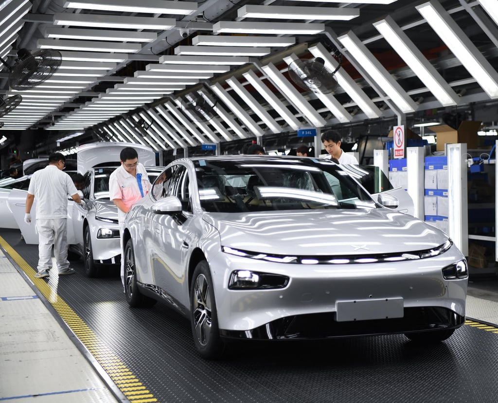 Workers check a new Xpeng EV at the end of an assembly line in Zhaoqing, in southeast China’s Guangdong province, on October 09, 2023. Photo: Xinhua