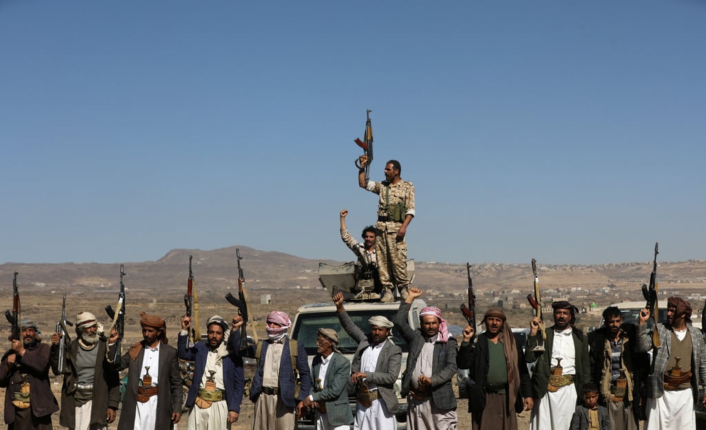 Houthi fighters and tribal supporters hold up their firearms during a protest against recent US-led strikes on Houthi targets, near Sanaa, Yemen on Sunday. Photo: Reuters