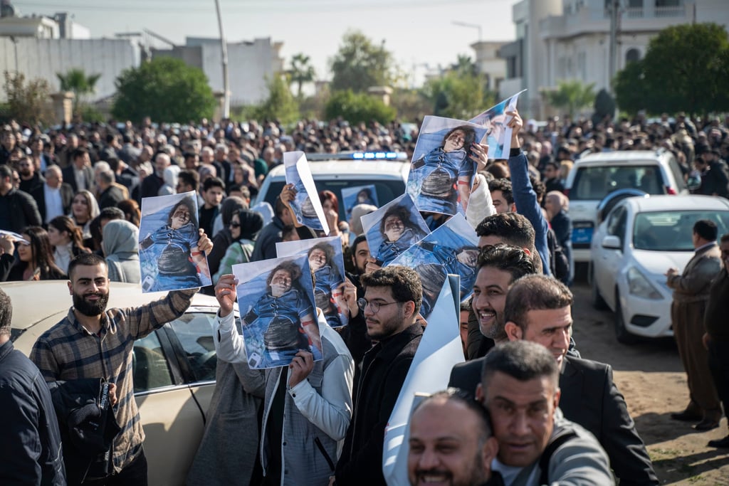 People hold photos of a child killed in Iranian strikes during a protest in front of the UN office in Irbil, Iraq on Tuesday. Photo: AP