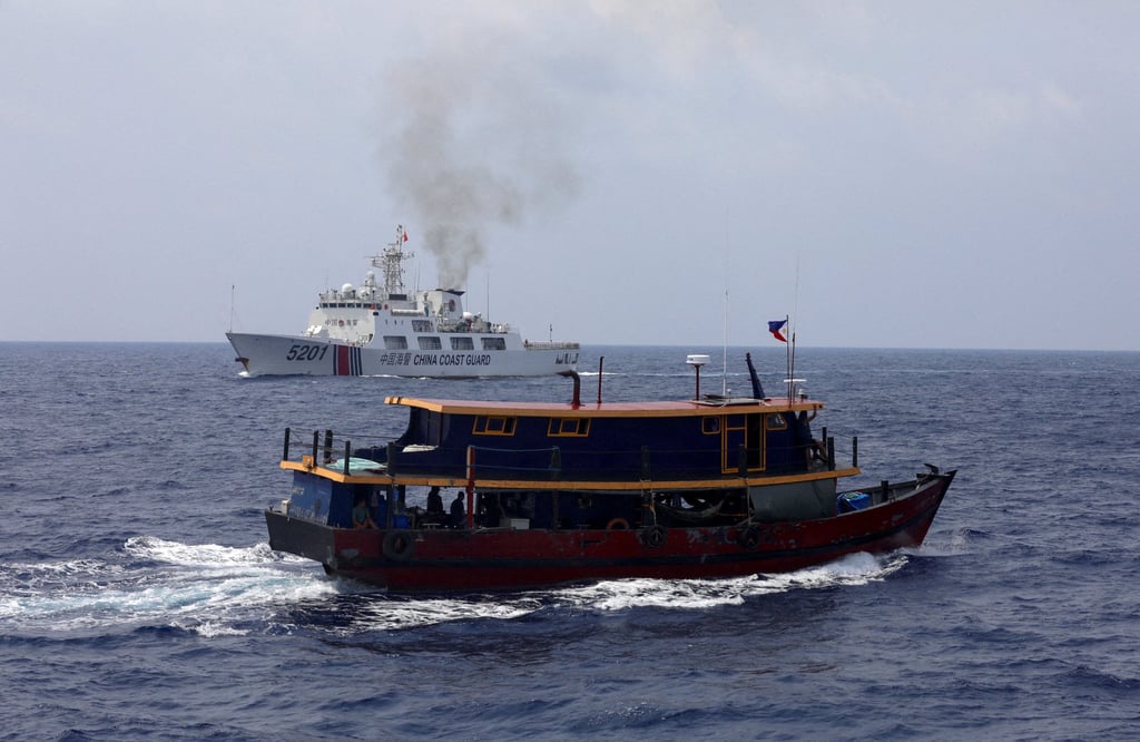 A Philippine supply boat sails near a Chinese Coast Guard ship during a resupply mission for Filipino troops stationed at a grounded warship in the South China Sea, on October 4, 2023. Photo: Reuters A Philippine supply boat sails near a Chinese Coast Guard ship during a resupply mission for Filipino troops stationed at a grounded warship in the South China Sea, on October 4, 2023. Photo: Reuters