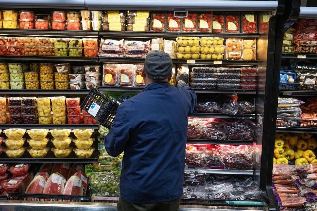 A worker stocks produce at a Shop Fair Market in the Brooklyn borough of New York, US, on December 26. In the Bank of America’s latest global fund manager survey, 21 per cent of respondents believed that the biggest tail-risk in markets was higher-than-expected inflation. Photo: Bloomberg