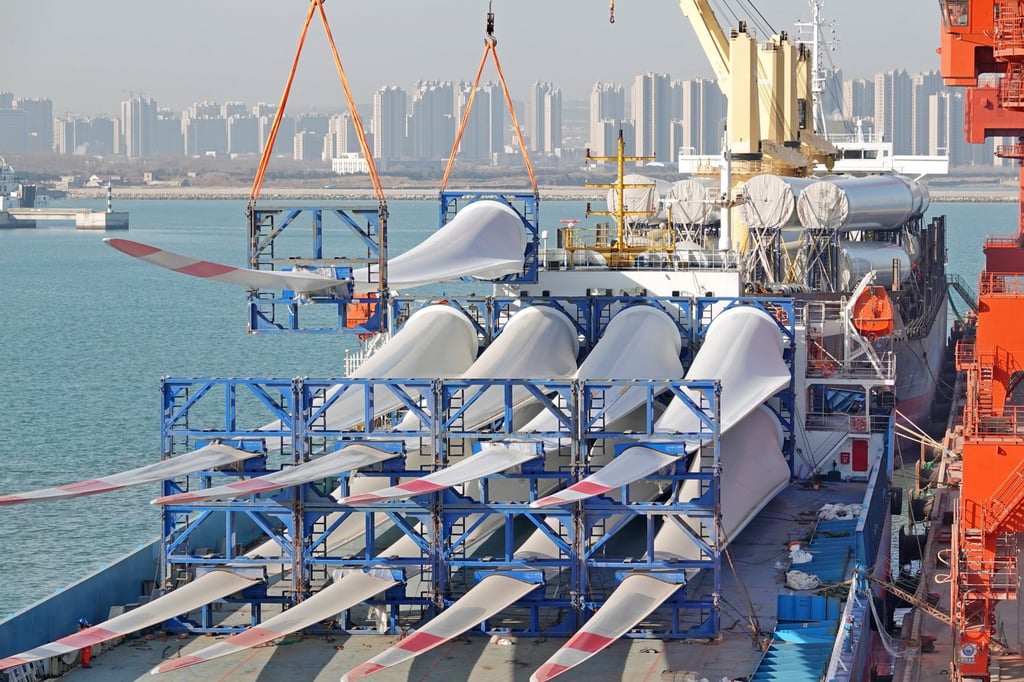 A crane loads wind turbine blades for a cargo ship at the Penglai port area of Yantai Port in east China’s Shandong province on March 2, 2023. Photo: CFOTO/Future Publishing via Getty Images